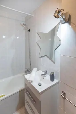 a white bathroom with a sink and a shower at JacobeAndo in Sarria
