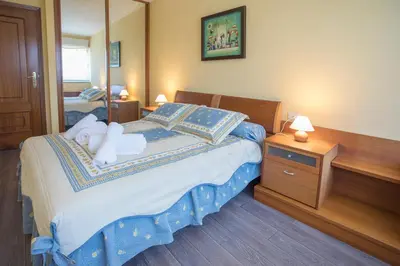 a bedroom with a bed with two towels on it at JacobeAndo in Sarria