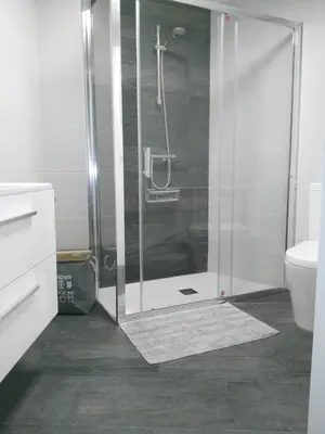 a shower with a glass door in a bathroom at La Guariza in Villablino