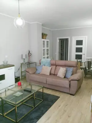 a living room with a couch and a table at La Guariza in Villablino