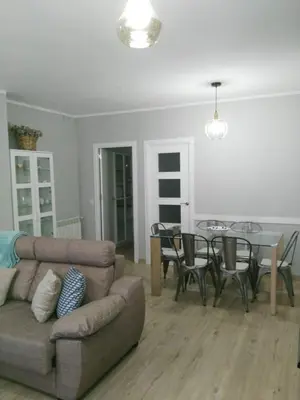 a living room with a couch and a table at La Guariza in Villablino