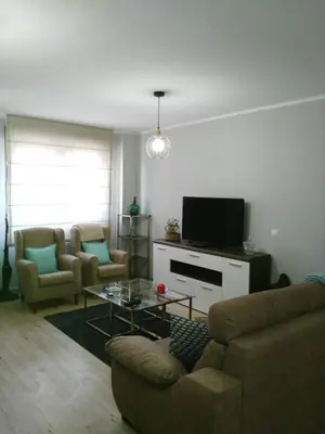 a living room with a couch and a tv at La Guariza in Villablino