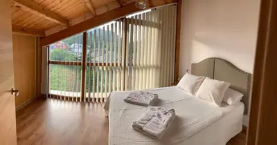 a bedroom with a bed with two towels on it at La casa de Lucas y Alex in Ponferrada