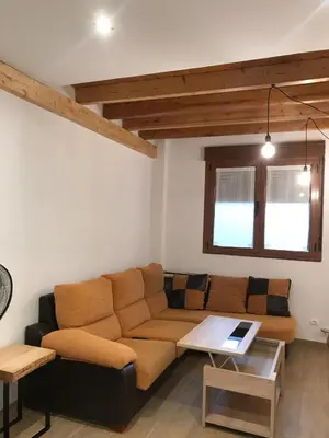 a living room with a couch and a table at La casa de Lucas y Alex in Ponferrada