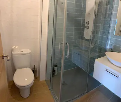a bathroom with a shower with a toilet and a sink at La casa de Lucas y Alex in Ponferrada
