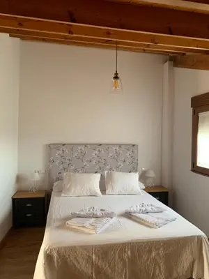 a bedroom with a large bed with two towels on it at La casa de Lucas y Alex in Ponferrada
