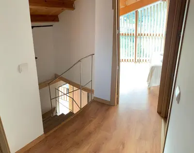 a staircase in a house with a glass railing at La casa de Lucas y Alex in Ponferrada