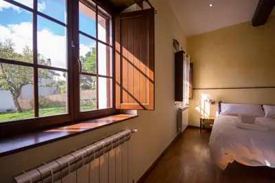 a bedroom with a bed and a window at O Canto da Terra in Pantón