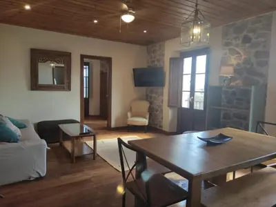 a living room with a table and a couch at O Canto da Terra in Pantón