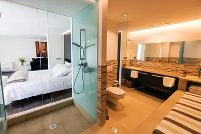 a bathroom with a shower and a toilet and a bed at Exclusiva vivienda de lujo in Foz