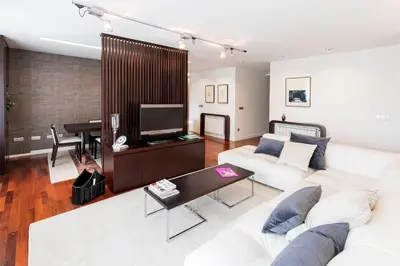 a living room with a white couch and a television at Exclusiva vivienda de lujo in Foz