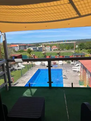 a view of a swimming pool through a window at Casa Costoya in Arzúa