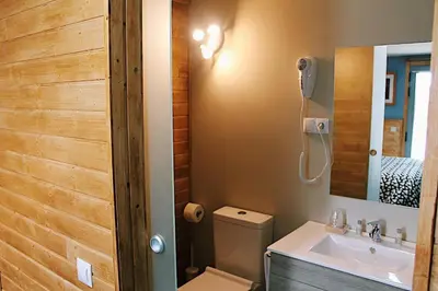 a bathroom with a toilet and a sink and a mirror at Casa Costoya in Arzúa
