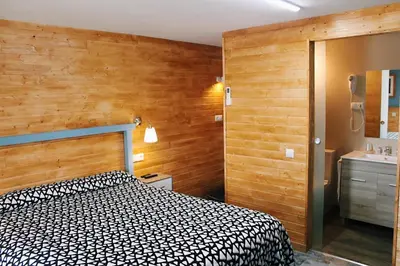 a bedroom with a black and white bed and a sink at Casa Costoya in Arzúa