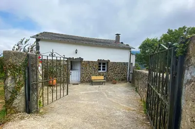 a gate to a house with a bench in front of it at Casa Rural As Bodegas - Villa Rustica Asturias - Boal in Boal