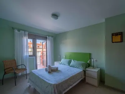 a bedroom with a bed and a chair and a window at Apartment Edificio Bahia II by Interhome in Miño