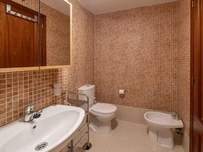 a bathroom with a toilet and a sink at Apartment Edificio Bahia II by Interhome in Miño