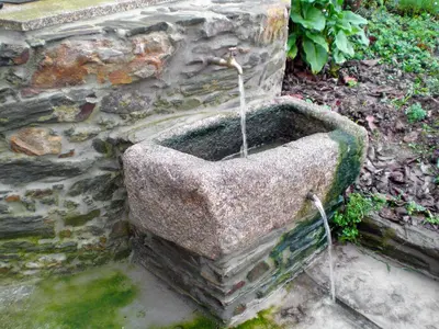 a stone water fountain on the side of a stone wall at Holiday Home El Olivo by Interhome in Puentedeume