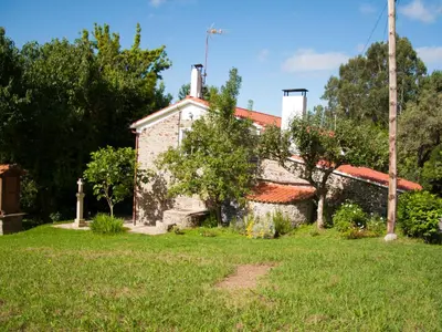 an old stone building in a yard with a grass field at Holiday Home El Olivo by Interhome in Puentedeume
