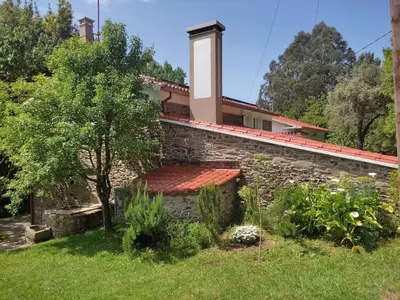 a stone wall with a bench in front of a house at Holiday Home El Olivo by Interhome in Puentedeume