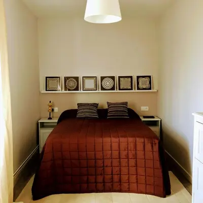 a bedroom with a bed with a red blanket at La Barranca in Barreiros