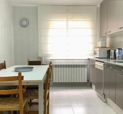 a kitchen with a table and chairs and a microwave at La Barranca in Barreiros