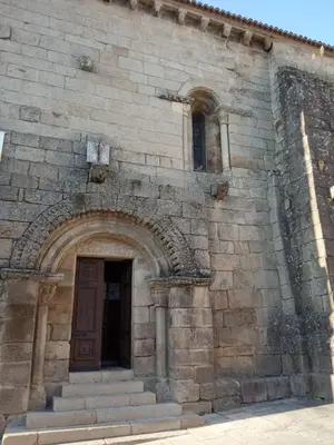 an old stone building with a door and stairs at Vivenda turística CENTRO HISTÓRICO in Allariz