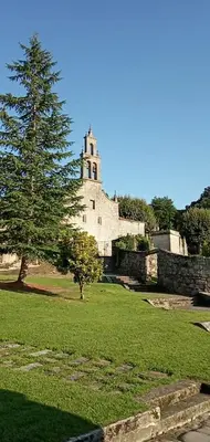a large building with a tree in a field at Vivenda turística CENTRO HISTÓRICO in Allariz