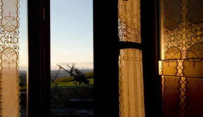 a window with a view of a sculpture in the distance at Casa da Lembranza in Fonsagrada