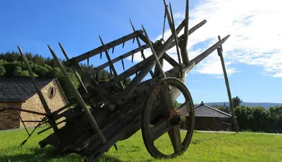 a large metal object sitting on top of a field at Casa da Lembranza in Fonsagrada