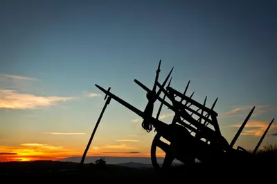 a silhouette of a windmill in front of a sunset at Casa da Lembranza in Fonsagrada