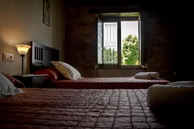 a bedroom with two beds and a window at Casa da Lembranza in Fonsagrada