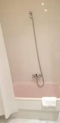 a bathroom with a tub with a shower at Hospedaje O Camiño in O Barco de Valdeorras