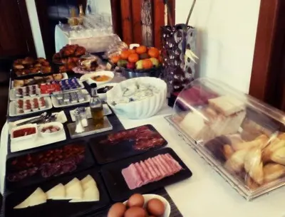 a table filled with different types of food on at Hospedaje O Camiño in O Barco de Valdeorras