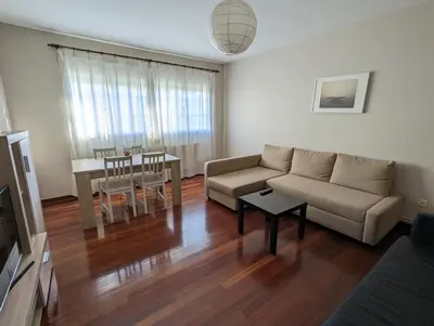 a living room with a couch and a table at Apartamentos Turísticos Guillermo in Palas de Rei