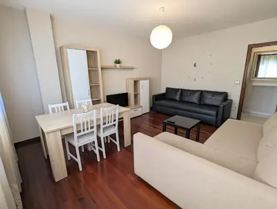 a living room with a couch and a table at Apartamentos Turísticos Guillermo in Palas de Rei