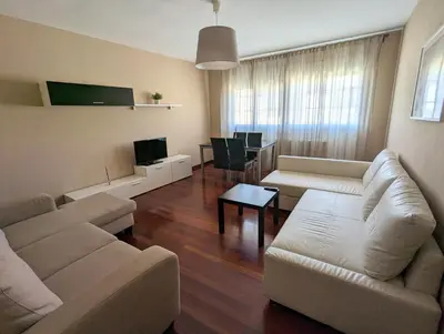 a living room with a couch and a table at Apartamentos Turísticos Guillermo in Palas de Rei