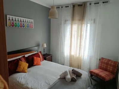 a bedroom with a bed with two towels on it at Buen camino in Santiago de Compostela