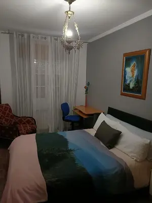 a bedroom with a bed and a chair and a table at Buen camino in Santiago de Compostela