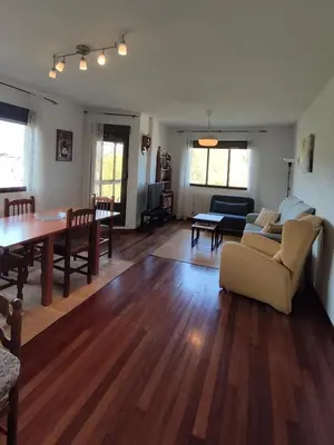 a living room with a couch and a table at DÚPLEX SANABRIA in El Puente