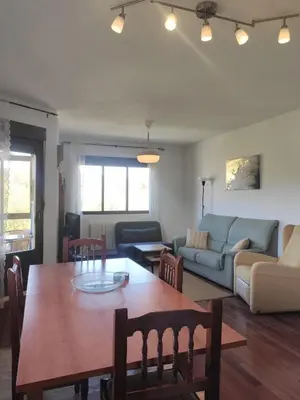 a living room with a table and a couch at DÚPLEX SANABRIA in El Puente