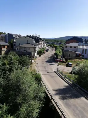 a street in a town with houses and a road at DÚPLEX SANABRIA in El Puente