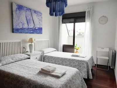 a hotel room with two beds and a window at DÚPLEX SANABRIA in El Puente
