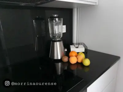 a blender sitting on a counter with fruit on it at Morriña in Ourense