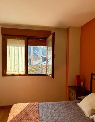 a white bathroom with a sink and a mirror at Hostal El Horno in Molinaseca