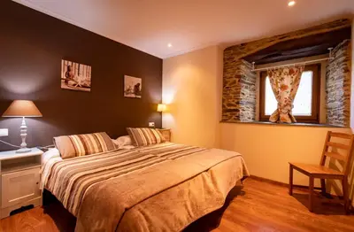 a bedroom with a large bed and a window at Vieiro Verde in Vieiro