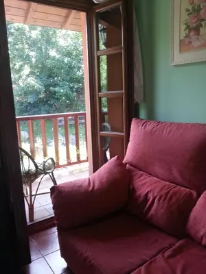a dining room with a table and a window at Apartamentos Rurales Buenamadre in Pola de Somiedo