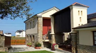 an external view of a house with a patio at Apartamentos Rurales Casanova in Tapia de Casariego