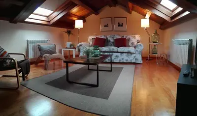 a living room with a couch and a table at Apartamentos Rurales Casanova in Tapia de Casariego