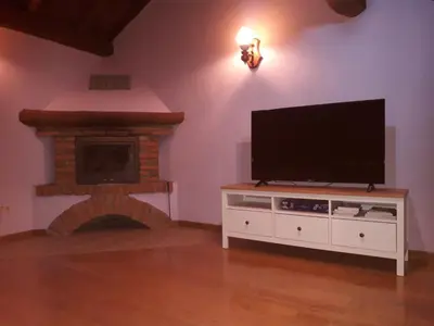 a living room with a flat screen tv and a fireplace at Casa Serafo in Saliencia